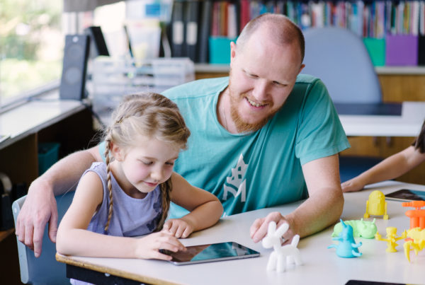 Roland Peddie with student in classroom