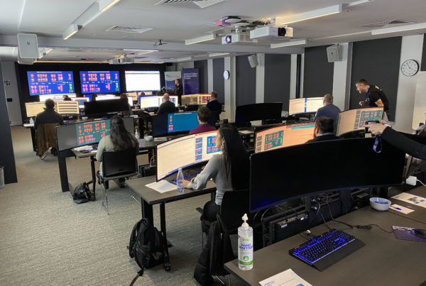A room of people working at the Australian Cyber Collaboration Centre
