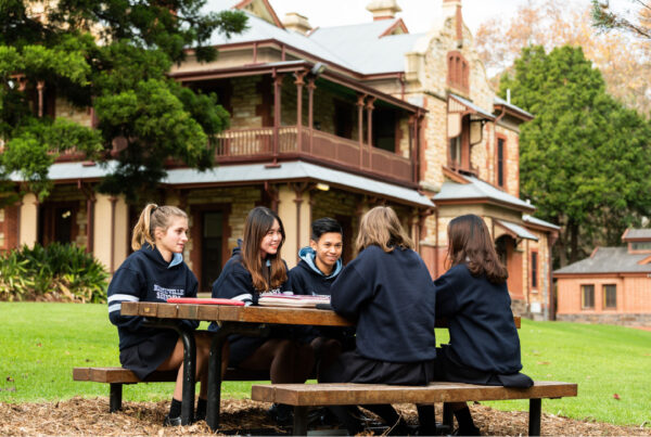 Marryatville High School building with students sitting on a bench